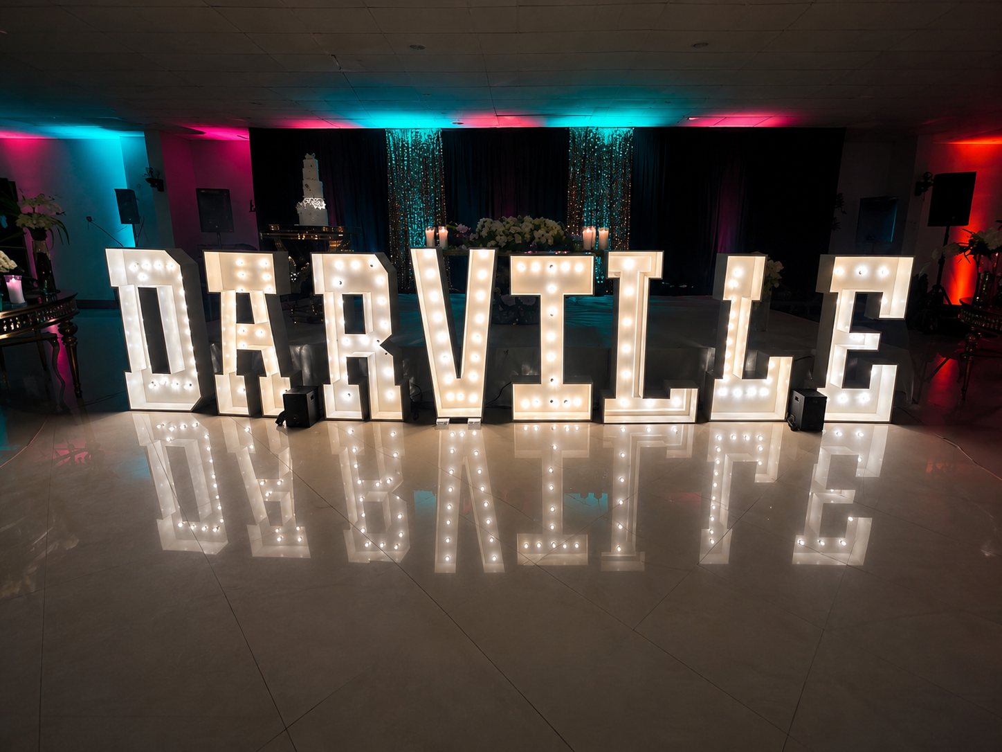 DARVILLE marquee letters reflected on a polished ballroom floor